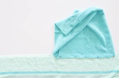 a blue towel laying on top of a white table