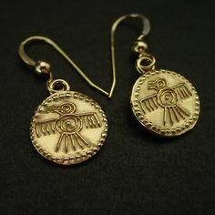 "Hand carved tiny quetzal art bird earrings symbol of the Aztec god Quetzalcoatl. The quetzal is a rare paradisiac colorful bird of Mesoamerica. In the worldview of the Mayan and Aztec cultures, the quetzal occupied a very important place. This beautifully plumaged bird symbolized the feathered serpent, the great god Quetzalcóatl or Kukulkán, who was in charge of protecting heaven and earth. With its serpent form, but crowned with quetzal feathers, Quetzalcóatl was the god of the air. He's a deity that appears repeatedly as a symbol in the pyramids and representations of both cultures. Today the quetzal is the national bird of Guatemala, and their national currency has been named after it.  - Hand carved earrings. - Solid yellow bronze also called jeweler gold bronze charms. - 1/5\" charms