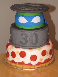 a three tiered cake decorated to look like the teenage mutants are stacked on top of each other