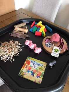 a black tray topped with toys and other items