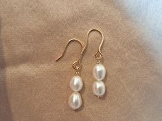 14K Gold Filled Pearl Earrings Bridesmaid Pearl Earrings White Pearl Earrings Pearl Hoop Earrings Tarnish and Water Resistant Earrings Wedding Pearl Earrings Stunning White A Grade Pearls on 14K Gold Fill Earwires These Pearls have a beautiful luster and are A Grade Pearls I have made these Earrings with Bridesmaids in mind & they come in our branded SC pouch as pictured  14K Gold Filled is considered a precious metal and the closest you can get to solid Gold Wire.    It is NOT to be confused with Gold Plating.   14K Gold Filled has 100 times more Gold than standard Gold Plated Jewelery  🧡 Tarnish Resistant 🧡 Water Resistant Gold Fill is more valuable and tarnish resistant, it does not flake or rub off. With care the Fill will last 10-30 years.  If you need to clean your hoops, simply fi Wedding Pearl Earrings, Bridesmaid Pearl Earrings, White Pearl Earrings, Bridesmaid Pearls, Pearl Earrings Wedding, White Pearl Earring, Earrings Bridesmaid, Pearl Hoop Earrings, Earrings Pearl