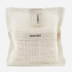 the merak pouch is made from white cotton and has a small zipper on it