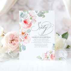 a white card with pink flowers and greenery