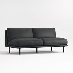 a gray couch sitting on top of a white floor