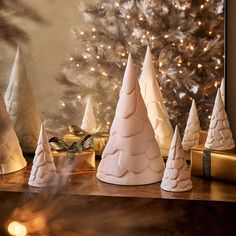 small white christmas trees sitting on top of a table