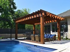 a pool with a wooden pergoline and chairs next to it