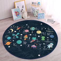 a child's room with a rug that has space themed letters on it