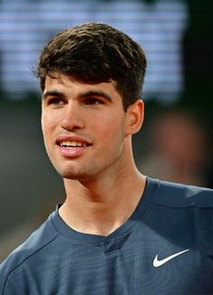 a close up of a tennis player wearing a blue shirt