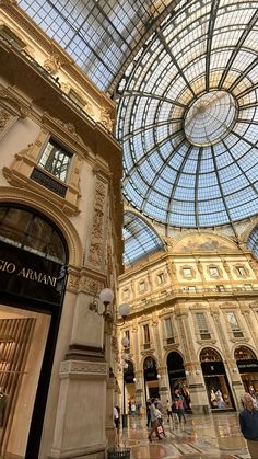 the inside of a shopping mall with people walking around