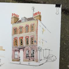 a drawing of a building on the side of a road