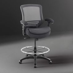 an office chair sitting on top of a metal stool