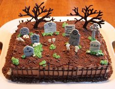 a cake decorated with tombstones and trees