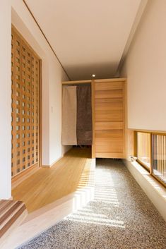 an empty room with wooden doors and carpeted flooring on either side of the door