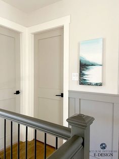 an empty room with white walls and wood flooring on the second floor, along with metal handrails