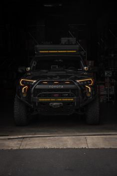 the front end of a vehicle in a dark garage