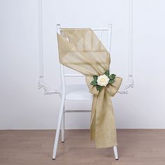 a chair with a flower on it and a burlap sash around the back