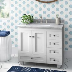 a bathroom vanity with blue and white wallpaper