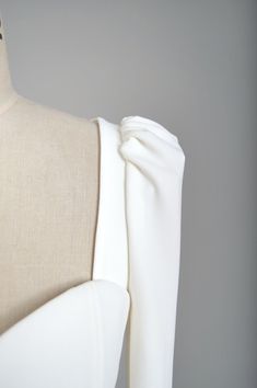 the back of a mannequin with white fabric on it