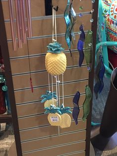 a wind chime with pineapples hanging from it's sides in a store