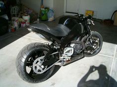 a black motorcycle parked in a garage