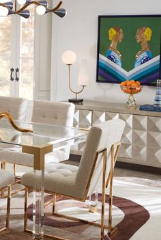 a glass dining table surrounded by beige chairs