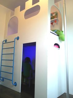 a child's room with a ladder to the ceiling