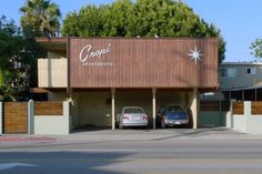 two cars parked in front of a building with a sign that says crepe apartments