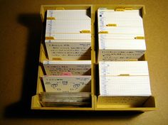 several yellow boxes with papers in them sitting on a table