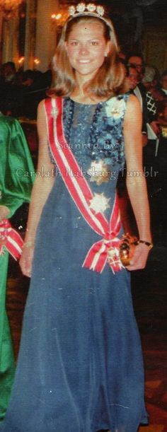 a woman in a blue dress standing next to another woman