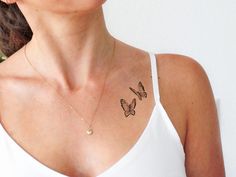 a woman with a butterfly tattoo on her chest