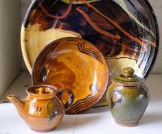 an assortment of pottery sitting on top of a table