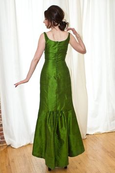 -Elegant scooped neckline which sits wide on the shoulders-Fitted through the bodice and waist, low empire seam-Flattering trumpet skirt with optional flounced train detail-Invisible center back zipper-Optional covered buttons as shown on back view on model (additional $100)-Silk shantung with poly china silk lining.  Dry clean only.Featured in apple green silk shantung with teal lining.   We have an x-small in-stock available for immediate delivery.X-smallbust      33waist     27hip         36l Fitted Green Evening Dress With Pleated Bodice, Fitted A-line Evening Dress With Lined Bodice, Empire Waist Gala Dress, Empire Waist Fitted Dress For Gala, A-line Evening Dress With Pleated Back, Fitted Empire Waist Dress For Gala, Elegant Fitted Evening Dress With Empire Waist, Classic Evening Dress With Fitted Bodice And Sleeveless Design, Classic Sleeveless Evening Dress With Fitted Bodice