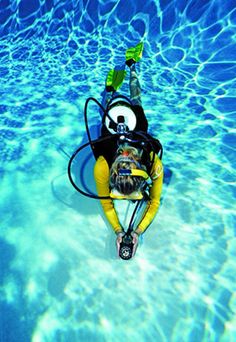 a man is swimming in the water with a mask on