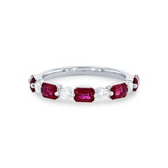 a white gold ring with three ruby stones on the sides and two diamonds in the middle