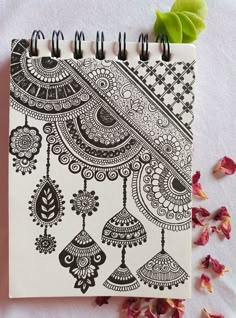 a spiral notebook with black and white designs on it