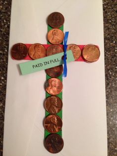 a cross made out of penns and paper with the word paid in full on it