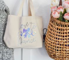 two baskets with flowers in them are next to each other on the wall and one is holding a bag