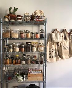 a metal shelving unit filled with lots of spices and other items next to a canvas bag