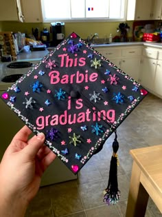 someone is holding up a graduation cap that says, this barbie is graduating