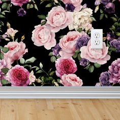 an electrical outlet cover with pink and purple flowers