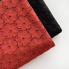 two pieces of black and red crocheted fabric