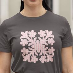 a woman wearing a t - shirt with pink and white designs on it