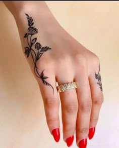 a woman's hand with a flower tattoo on it