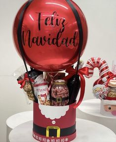 a large red balloon with the words feliz navidad on it in a gift box