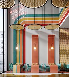 the interior of a restaurant with colorful striped walls and wooden flooring, hanging lights and chairs