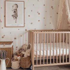 a baby's room with a crib, teddy bear and other items