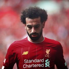 a close up of a soccer player wearing a red uniform