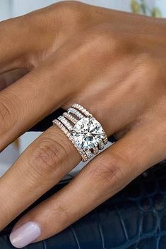 a woman's hand with a diamond ring on her finger