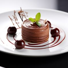 a piece of chocolate cake sitting on top of a white plate next to cherries