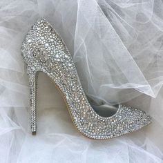 a high heeled shoe is adorned with swarozak crystals and tulle